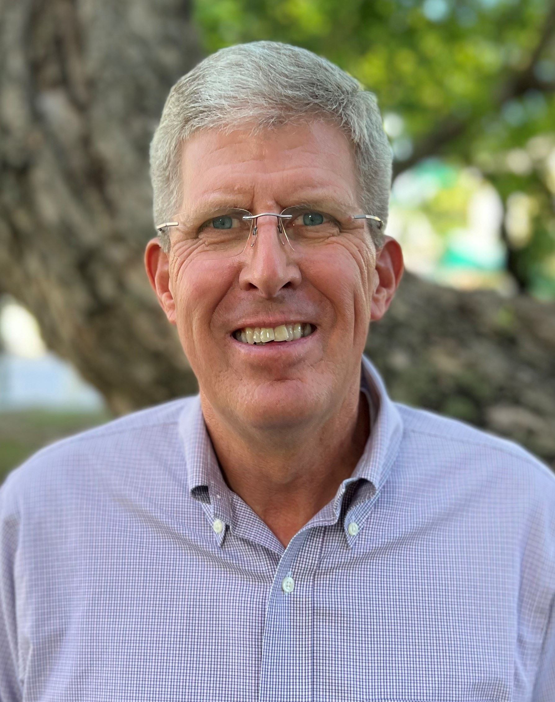 Jim Scholl Headshot outside with smile